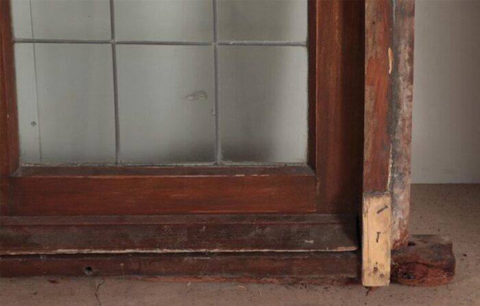 a four panel mahogany window set in frame with leaded glass having ship motif 3327