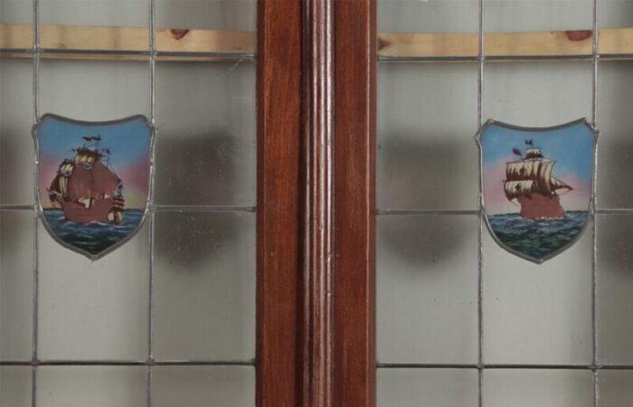 a four panel mahogany window set in frame with leaded glass having ship motif 9475