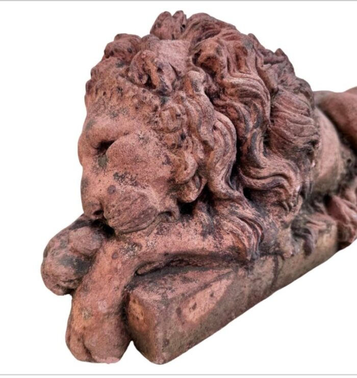 a pair of terracotta recumbent lion statues 0902