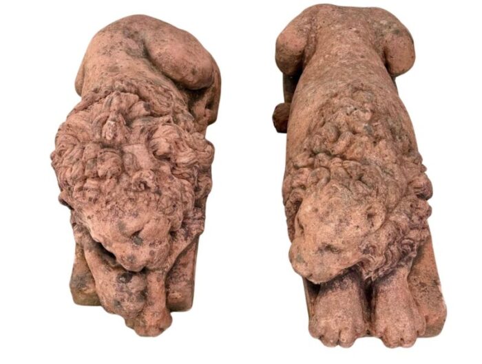 a pair of terracotta recumbent lion statues 1577