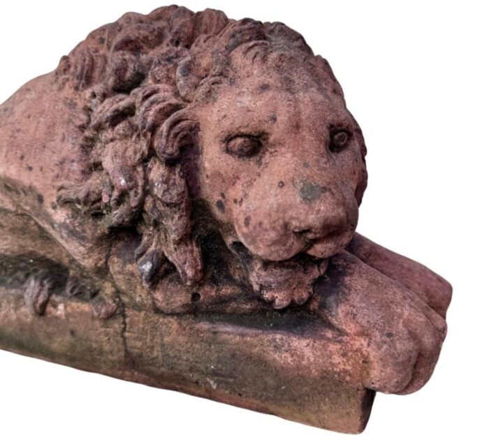 a pair of terracotta recumbent lion statues 4427