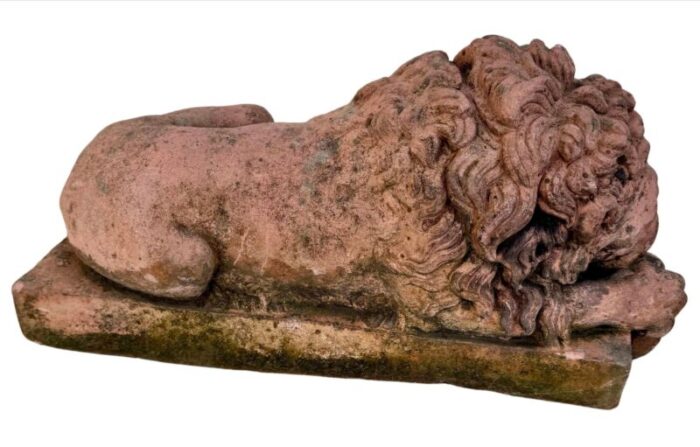 a pair of terracotta recumbent lion statues 6610