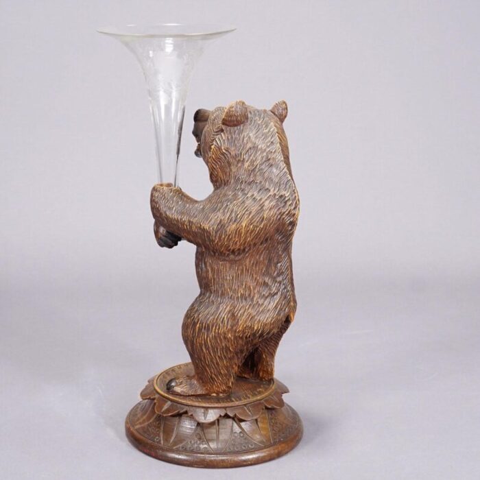 a wooden carved black forest bear with glass vase 3269