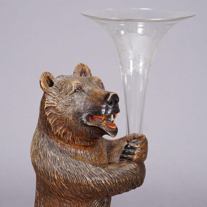 a wooden carved black forest bear with glass vase 6102