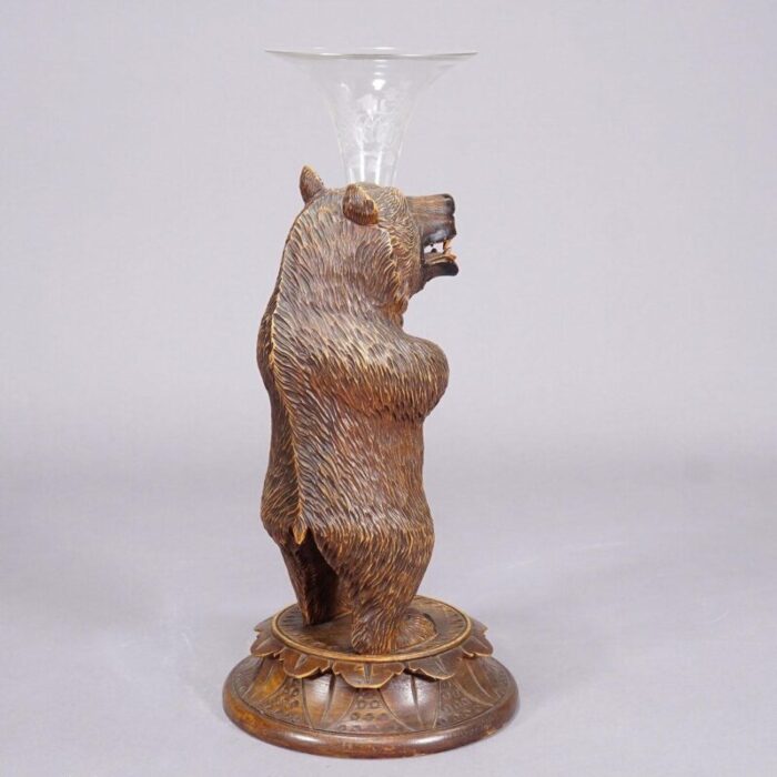 a wooden carved black forest bear with glass vase 8151