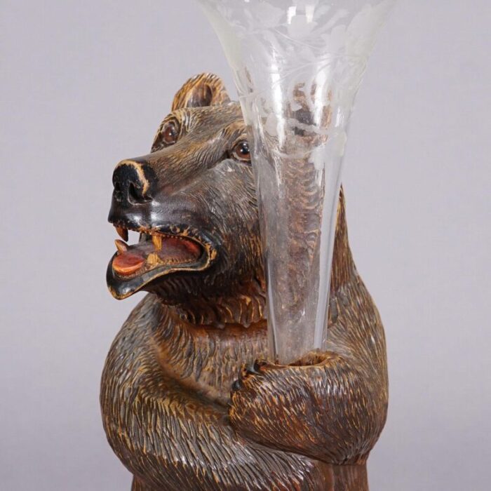 a wooden carved black forest bear with glass vase 8849