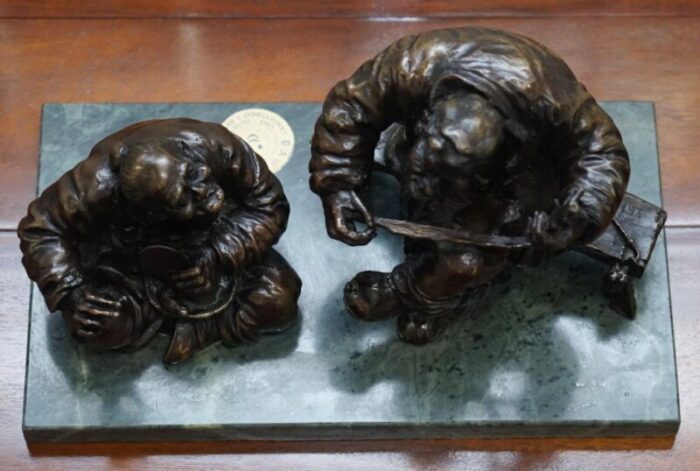 antique bronze statue of 2 men one a solid green soapstone base 12