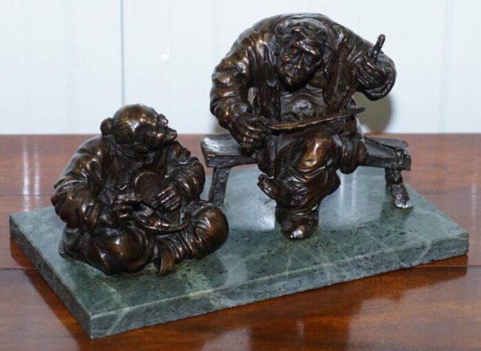 antique bronze statue of 2 men one a solid green soapstone base 2